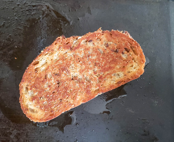 grilled cheese cooking on a griddle