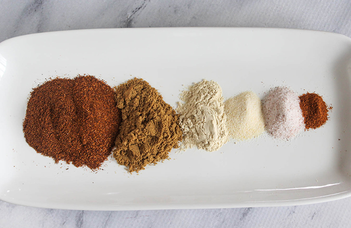 all of the spices on a plate in piles