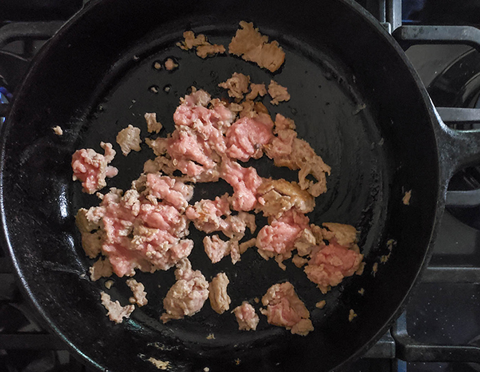 Ground pork cooking in a skillet