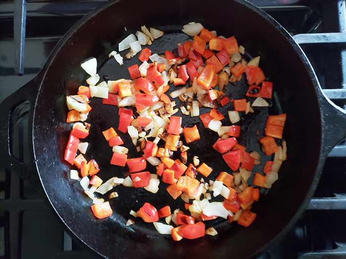 Step 3: peppers and onions cooking in a skillet