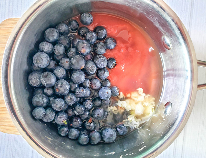 a picture of blueberry bbq sauce ingredients in a pan before they are cooked