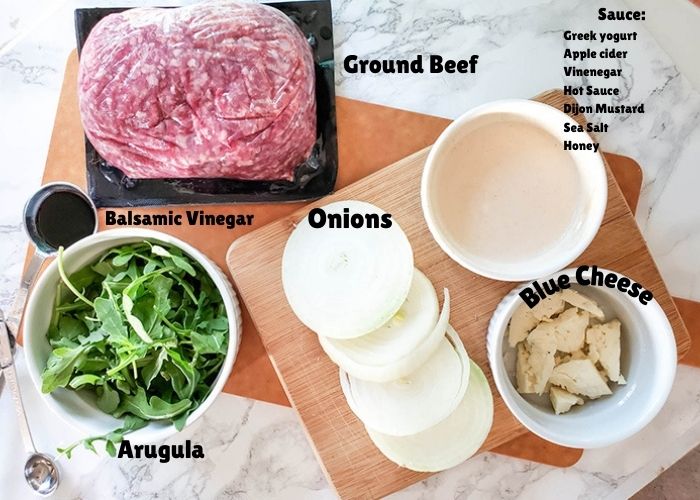 Ingredients for onion burgers on a cutting board
