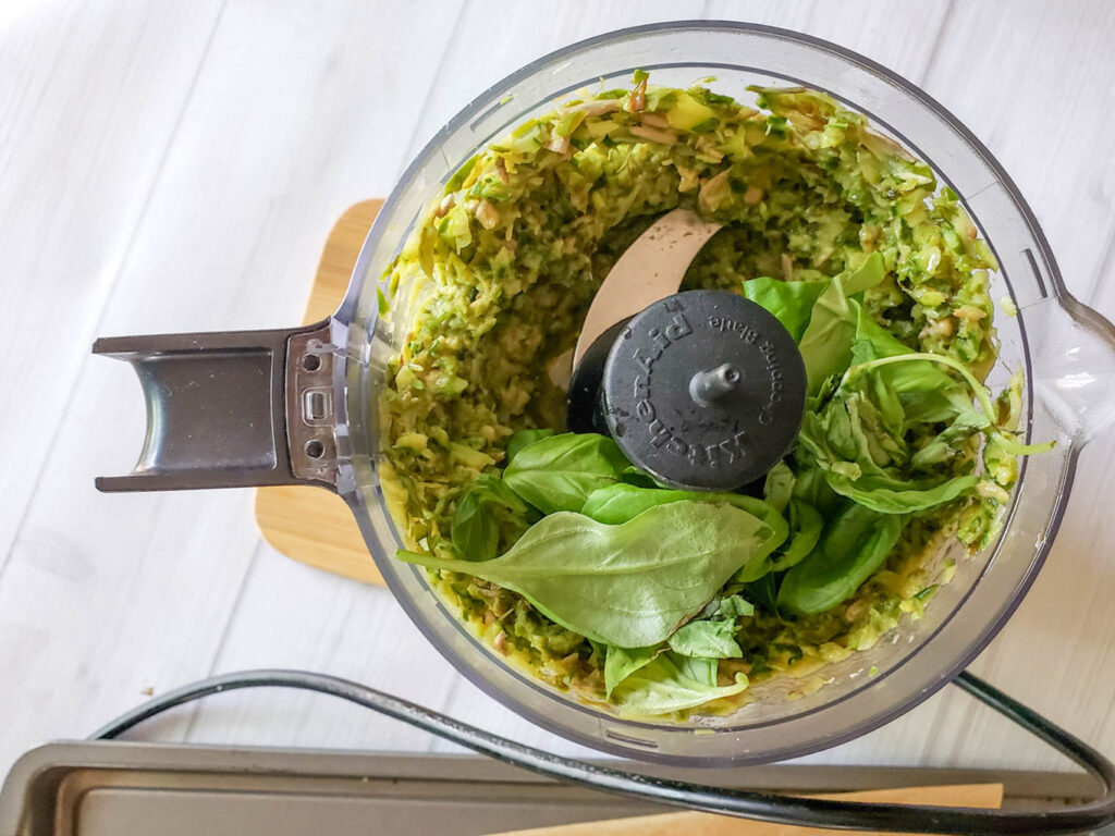 pesto mixture with basil in a food processor