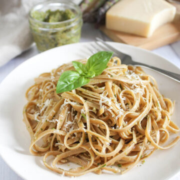 Asparagus pesto on top of linguine pasta with shredded cheese and basil on top
