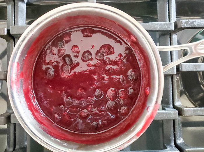 a picture of bbq sauce in a pan cooking on the stove 