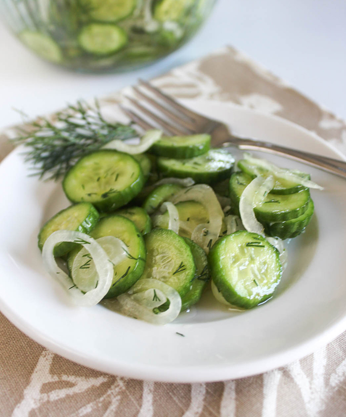 Cucumbers and onion salad on a plate with a fork