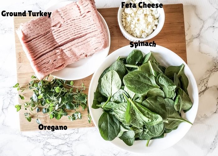 overhead view of ingredietns: ground turkey, oregano, spinach and feta cheese