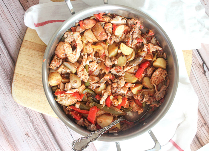 an overhead view of chicken murphy in a pan with a spoon