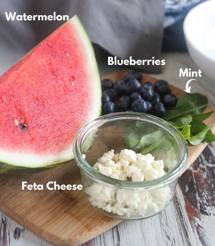 A picture of the fresh salad ingredients: watermelon, blueberries, mint and cheese