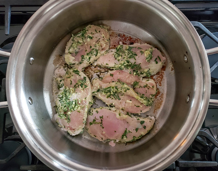 The boneless chicken cooking in a pan