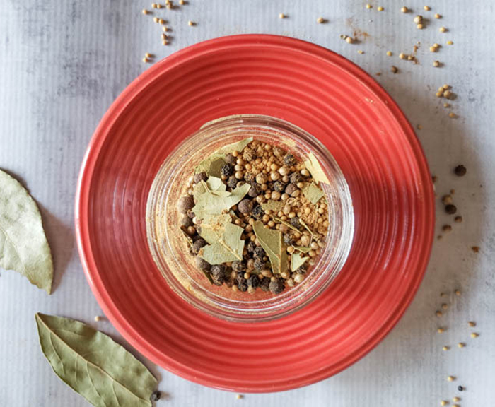 an overhead shot of pickle spices mixed together in a mason jar