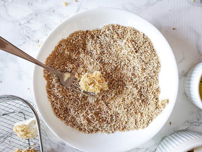 an overhead shot of cauliflower dipped in crumbs