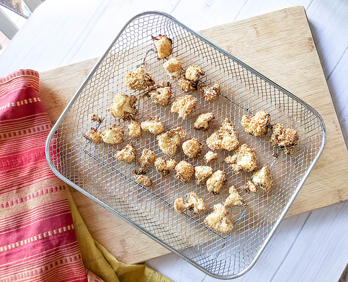 cooked cauliflower on a the air fryer tray