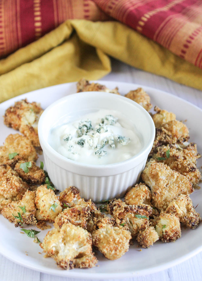 a picture of air fried cauliflower on a plate with dip