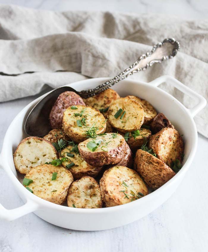 a bowl of air fryer potatoes with a spoon