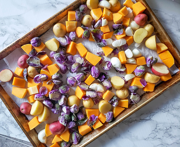 a pictue of potatoes andsweet potatoes on a baking sheet