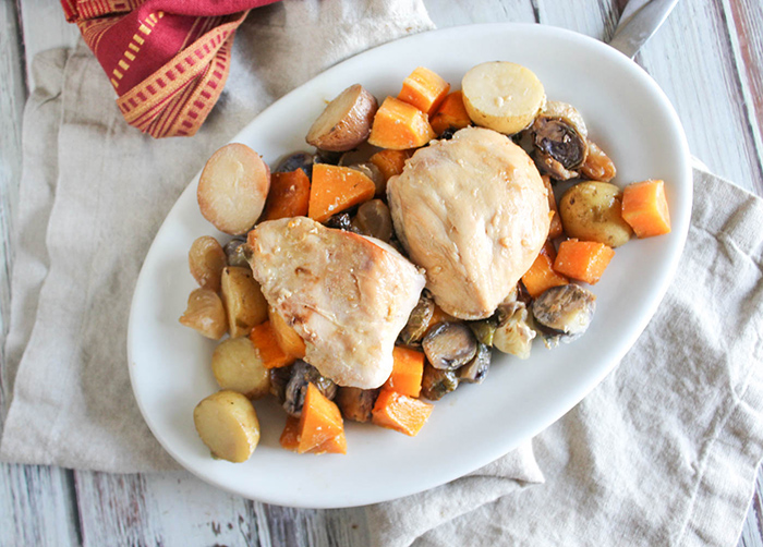 an overhead view of the chicken breasts and vegetables on a white platter