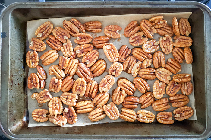 Pecan halves on a baking pan