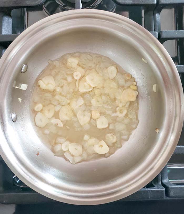 garlic and onions in a pan with white wine