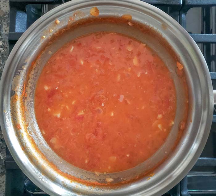 blush sauce with cream mixed in a pan