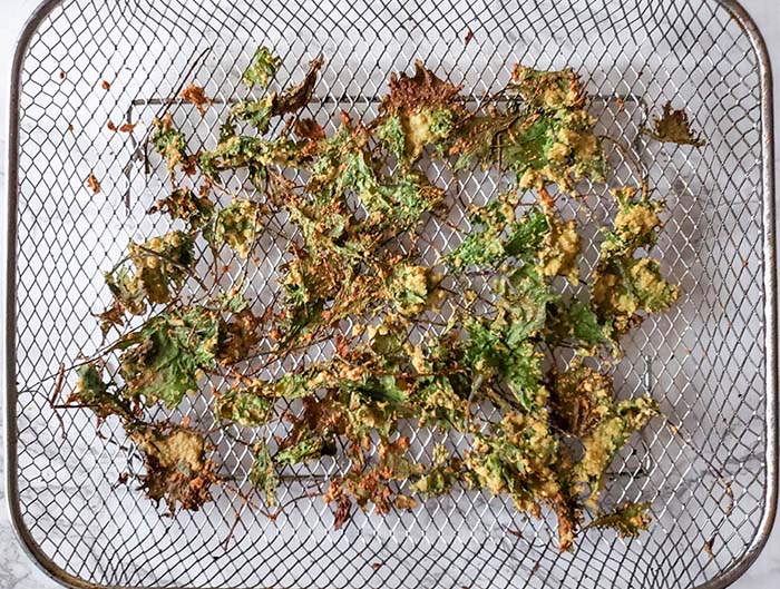 cooked kale chips on an air fryer tray