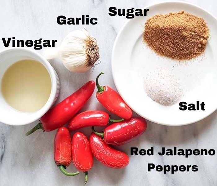 The ingredients for sriracha sauce: jalapeno peppers, vinegar, garlic, salt and sugar