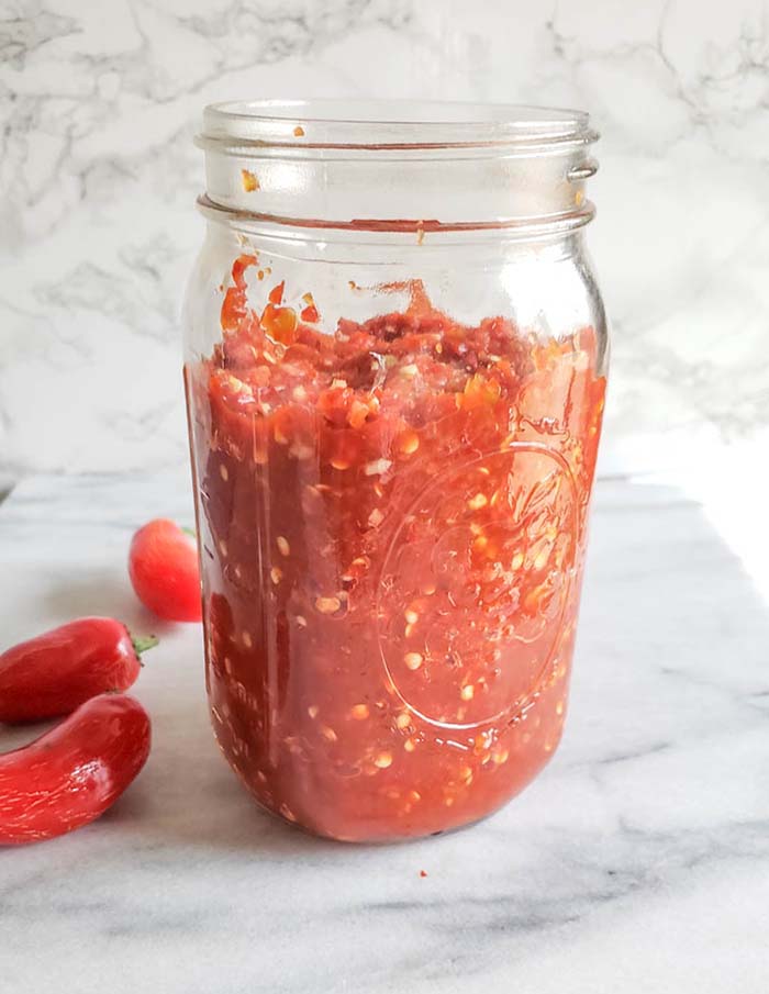 chopped jalapeno peppers in a mason jar