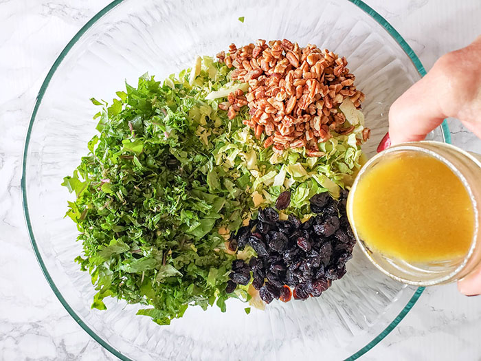 Pouring dressing over the salad ingredients