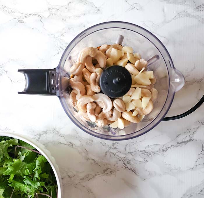 Overhead view of Cashews in food processor to make cashew cheese.