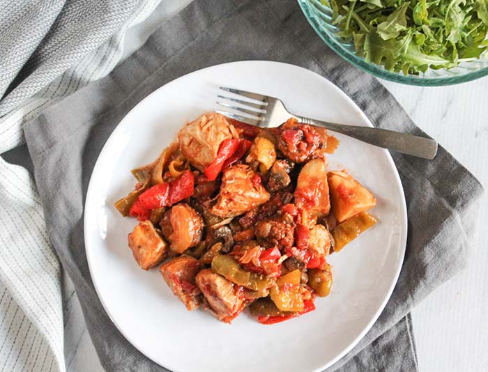 chicken murphy on a white plate with a fork