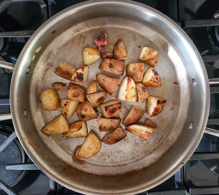 potatoes cooking in a skillet