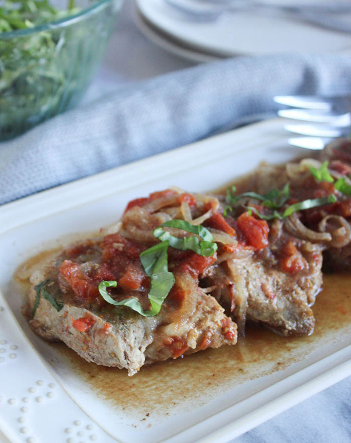 pork chops on a platter with a fork