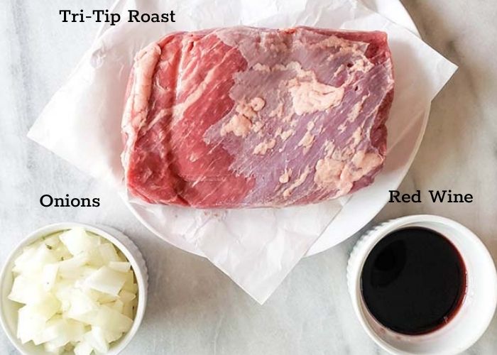 Slow cooker tri tip ingredients: onions, red wine and beef