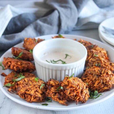 sweet potato fritters on a plate with dip