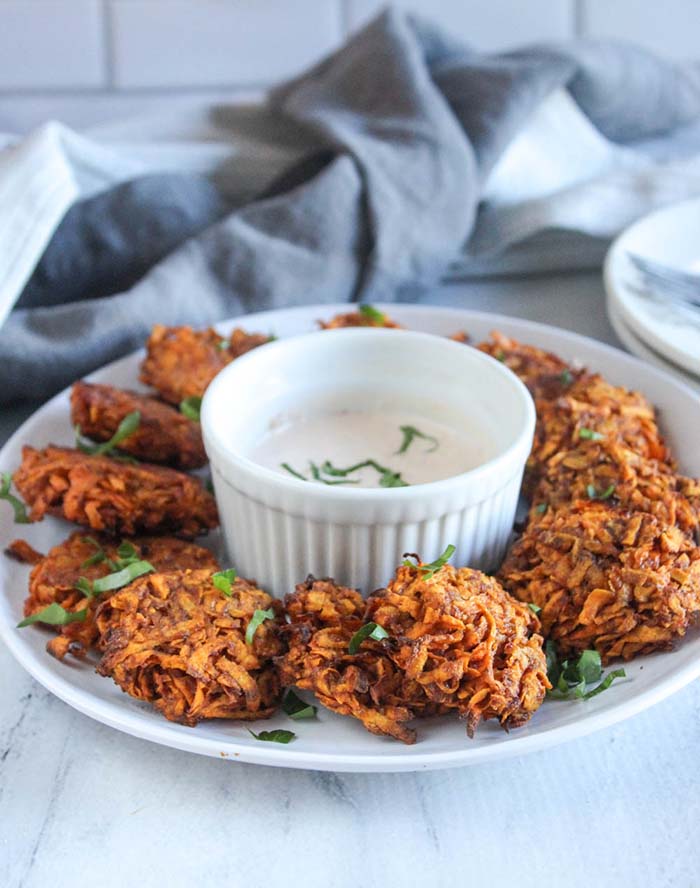 sweet potato fritters on a plate with dip