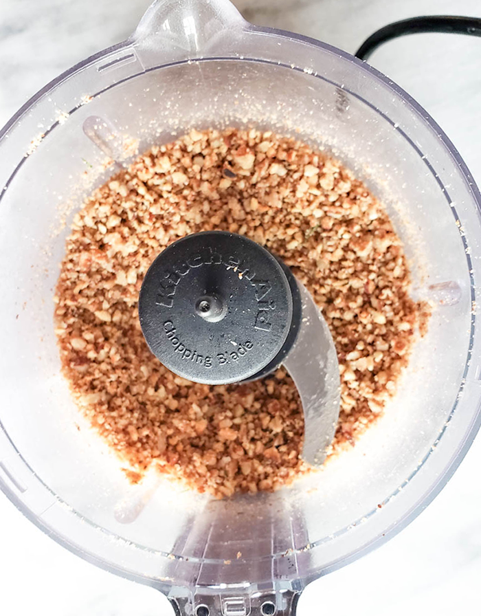 Chopped pecans in a food processor