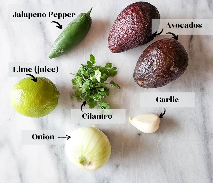 guacamole  ingredients of jalapeno pepper, lime, avocados, cilantro, onion and garlic