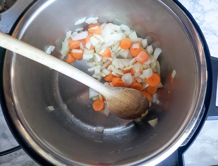 onions and carrots cooking in instant pot