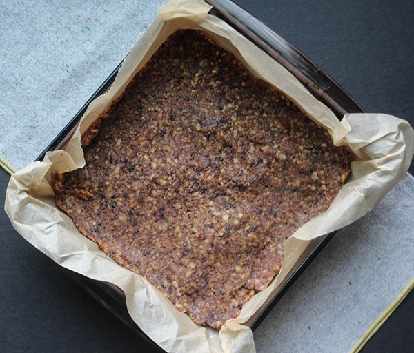 dates and walnut dough in a baking pan