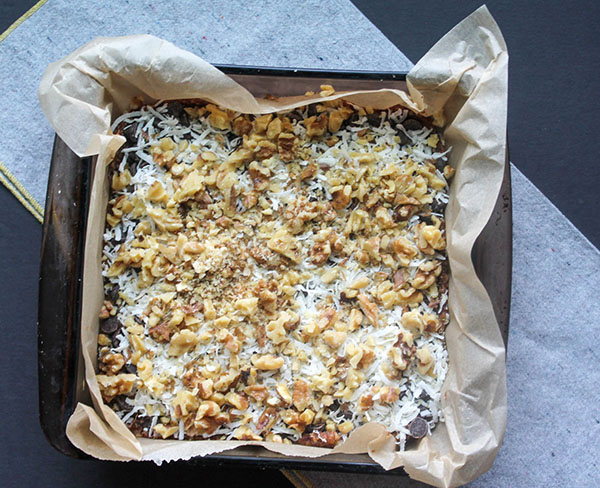 magic cookie bars in a pan ready for the oven