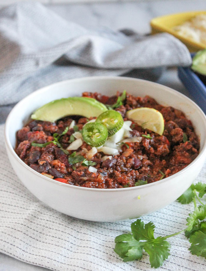 a close up view of chili ina white bowl