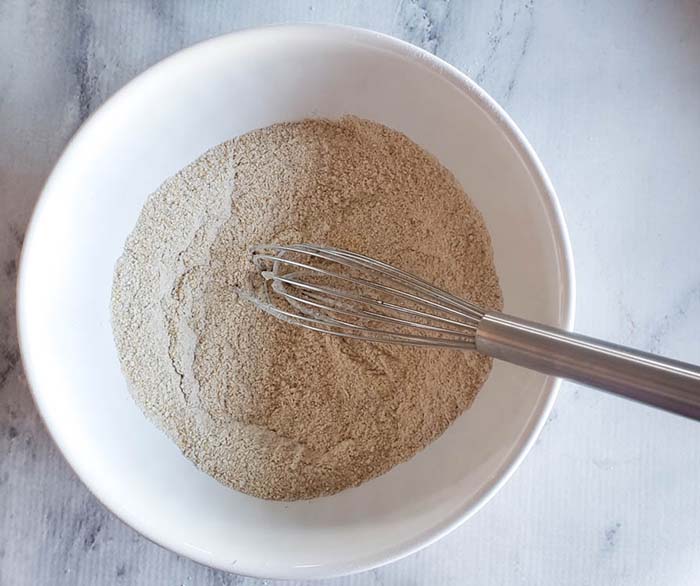 overhead view of cornmeal and flour in a bowl