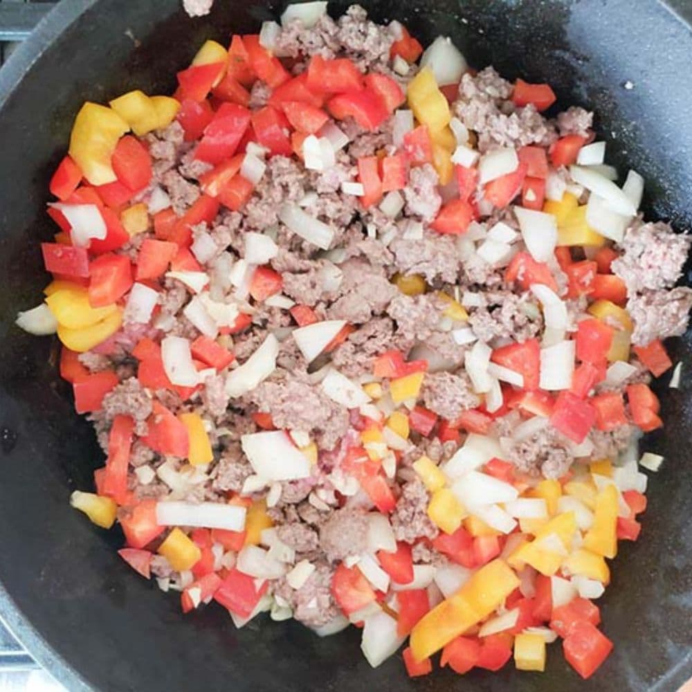 beer chili in a crockpot step 2 beef and veggies browning in a skillet
