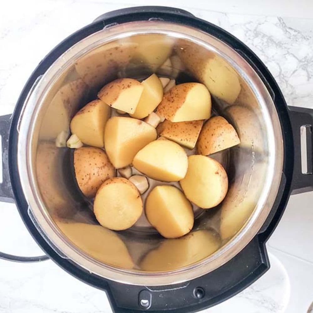Instant Pot Mashed Potatoes Process step 1, potato chunks in an instant pot.