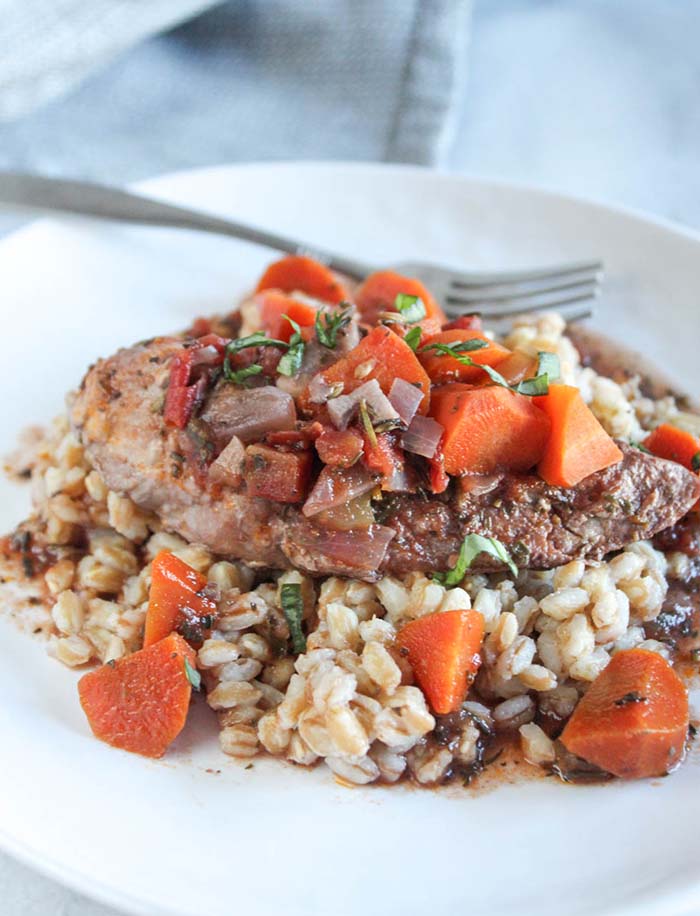 red wine chicken breast with farro on a plate