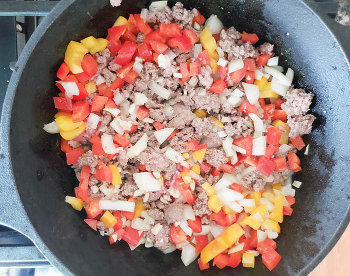 beef and vegetables cooking in a skillet