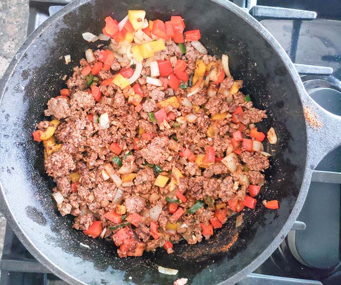 ground beef and vegetables cooking in skillet