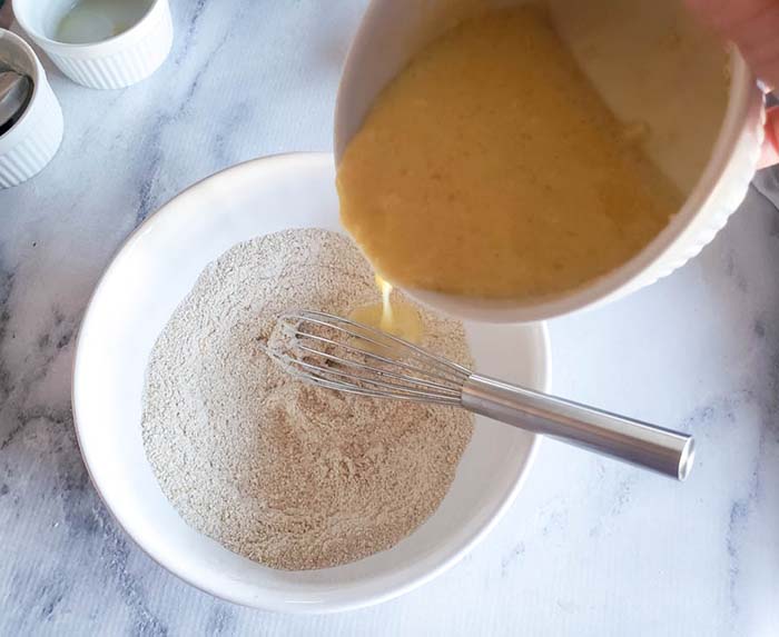 wet ingredients pouring into dry ingredients