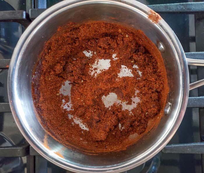 spices mixed with flour and oil in a saucepan