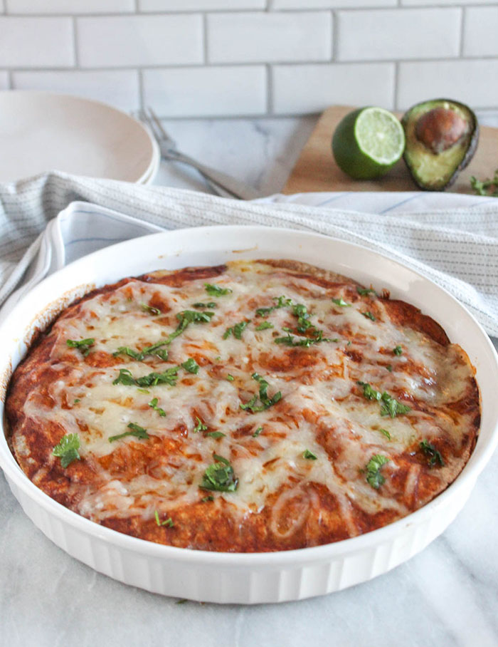 vegetarian enchilada casserole in a white casserole dish